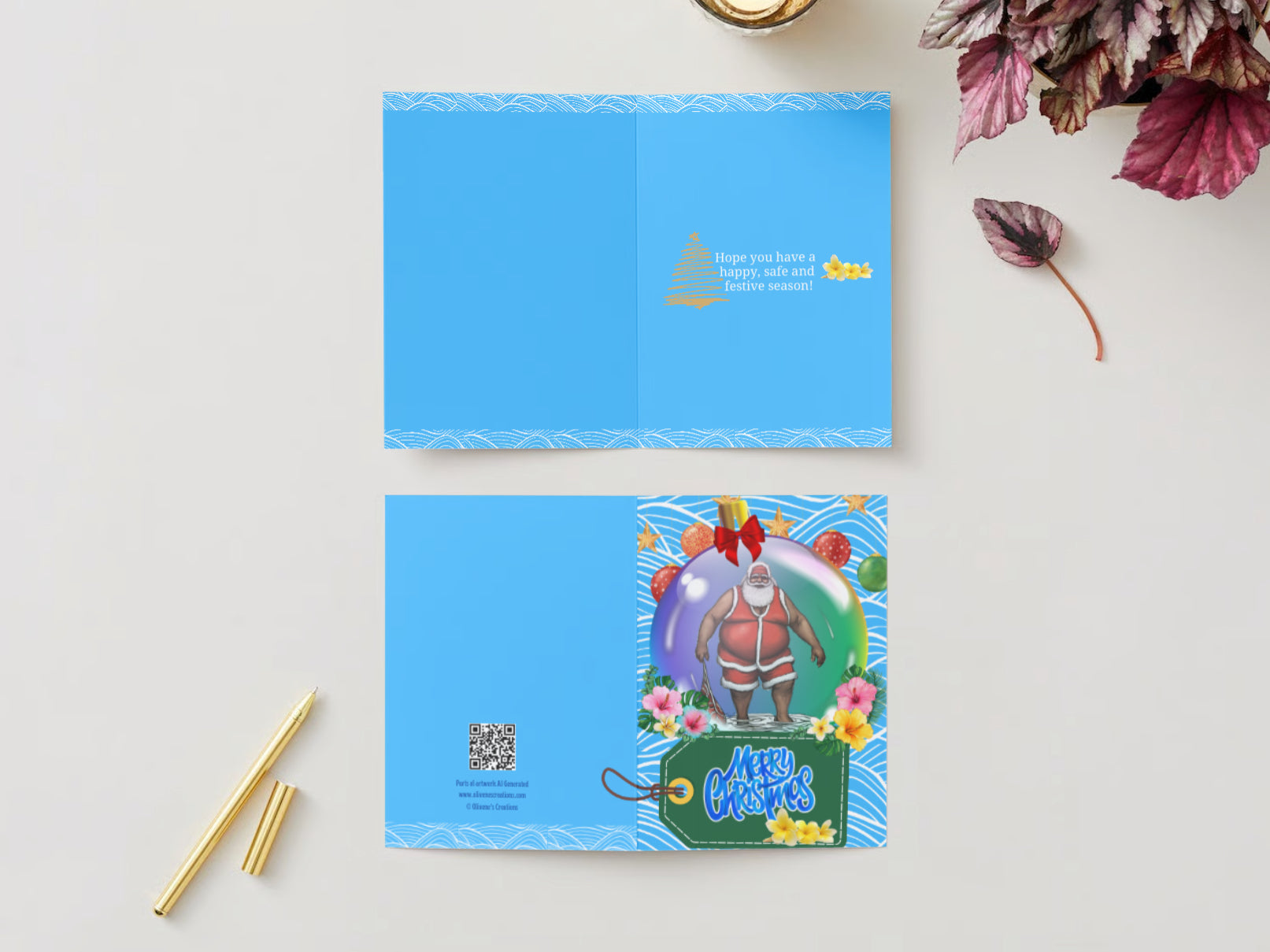 Greeting Card Black Santa in a bauble floating in the ocean with other Christmas coloured baubles and hibiscus flowers in various colours at the base of the bauble. A green gift tag under the bauble with the words “Merry Christmas” in blue and white and three yellow frangipani’s on the bottom left.